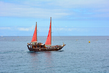 A sailboat with tourists on board at sea