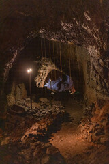 Exploring a volcanic cave in the Volcanic Caves Park at the foot of Villarrica volcano in Pucon,...