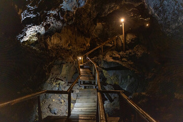 Exploring a volcanic cave in the Volcanic Caves Park at the foot of Villarrica volcano in Pucon,...