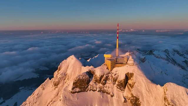 Aerial View of the Mountain Seantis in the Swiss Alps, Switzerland. Santis Weather Station, View Platform at sunset.