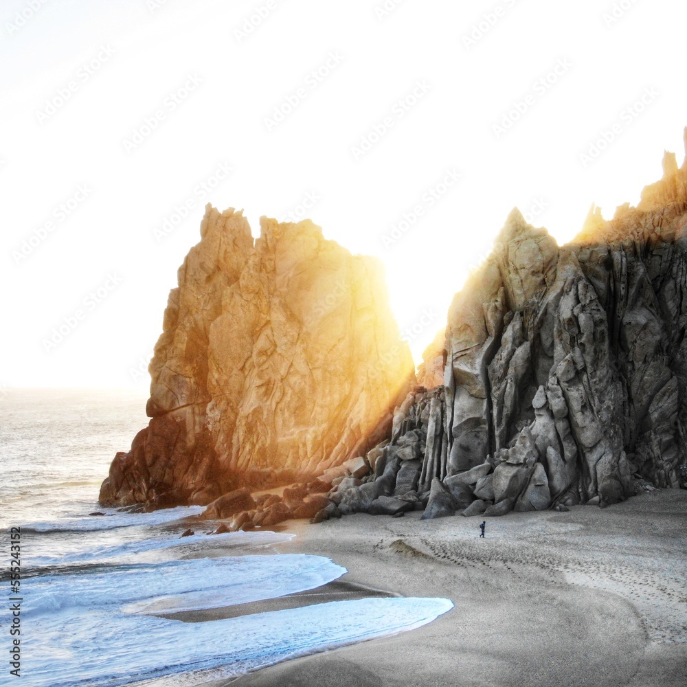 Wall mural aerial of stone cliffs on divorce beach in cabo, mexico at sunset