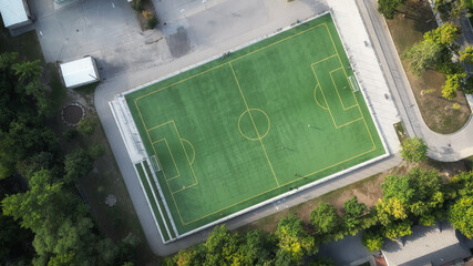 Aerial overhead shot of a soccer field at a school or park, with green grass. Drone image, in Toronto, Ontario, Canada. © Atomazul