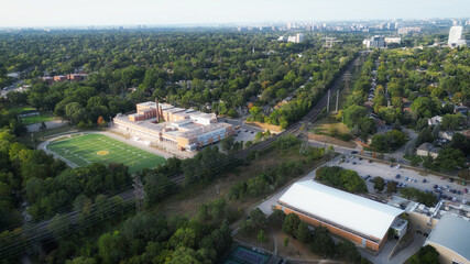 Aerial view over west Toronto, Ontario, Canada looking north-east over a football field and the...