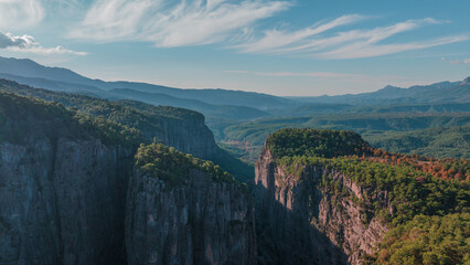 Magic landscape. Mountain gorge. Majestic canyon. Stone rocks and green trees. Aerial drone view. Sunny day