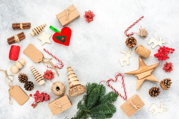 Christmas background, presents in brown boxes, pine cones, scissors, wooden ornaments on white wooden table