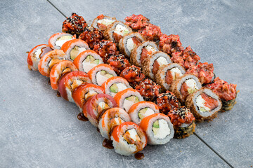 Set of japanese maki sushi rolls with tuna, salmon, avocado, cream cheese and red flying fish caviar.