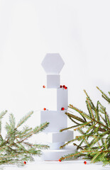 Minimalistic eco friendly scandinavian christmas background in white colors. Fir branches and white empty podium