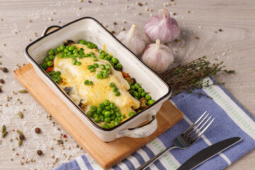 fish baked with cheese, green peas