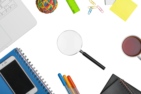 Office desk with a magnifying glass and office supplies