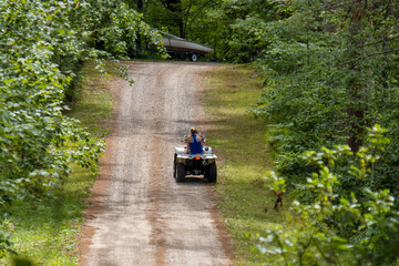 person riding ATV on dirt trail