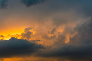 Beautiful storm cumulus clouds in the sky during sunrise or sunset, background