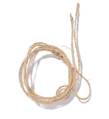 A skein of brown twine rope on a white isolated background, top view. Packing natural