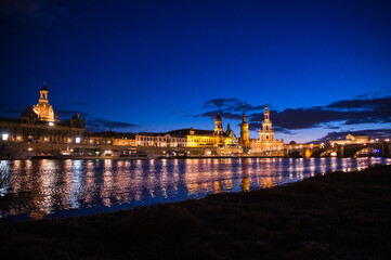 view of old town city dresden at nightfall with reflections in river elbe
