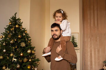 father and little girl daughter playing at home on Christmas holidays.