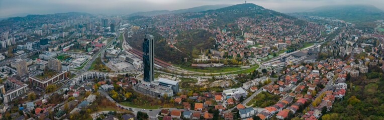 Fototapeta na wymiar Aerial view around the capital city Sarajevo in Bosnia and Herzegovina on a cloudy and fogy day in autumn.