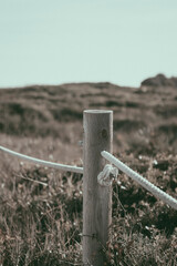 Fototapeta premium Wooden post with rope