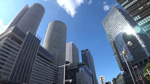 NAOGYA, JAPAN - OCTOBER 2022 : Time lapse shot of NAGOYA STATION and office buildings in sunny daytime. Business, transportation, travel and tourism concept video.