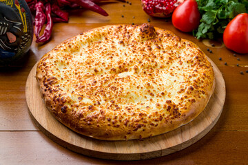 khachapuri with cheese, megrelian khachapuri, georgian cuisine on wooden table side view
