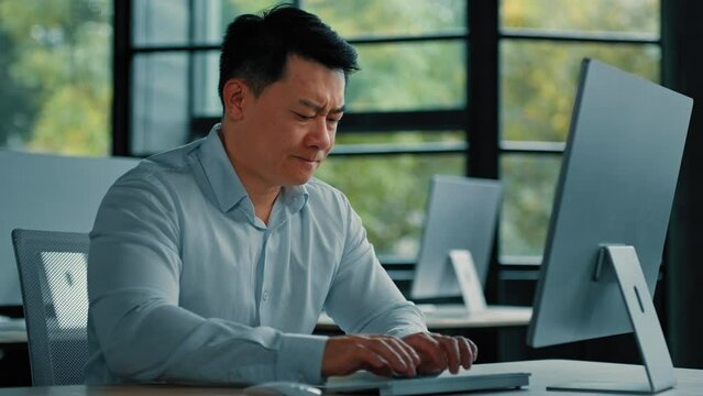 Chinese middle-aged businessman work on computer receive bad email notification wrong test result disappointed asian man business owner make mistake feel negative emotion professional defeat concept