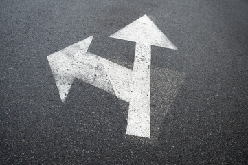 Arrow on asphalt showing direction