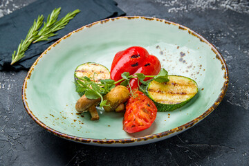grilled vegetables on a plate on grey table