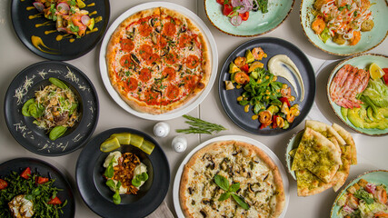 Pepperoni pizza, beefstroganoff, pizza with chicken and mushrooms, salad with shrimps, foccacia, pasta with beef, salad buratta top view