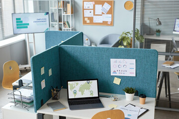 High angle view at office interior with workplaces separated by partition walls in neutral blue...