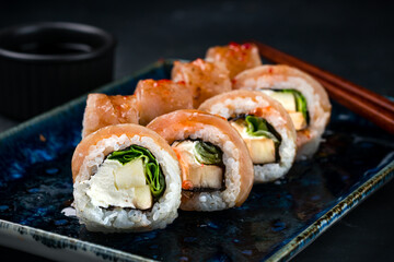 Sushi rolls with seared tuna, cream cheese, zucchini, lettuce and soy sauce.