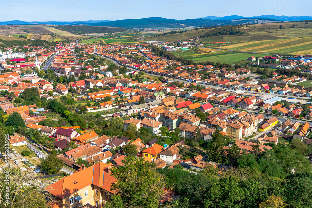 Wall mural aerial view of the town center with hills, buildings, streets, vegetation and surroundings in rupea,