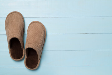 Man's slippers on wooden background, top view