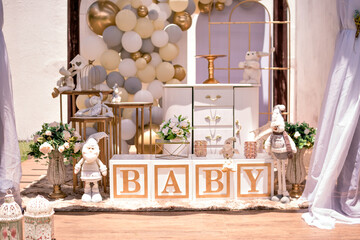 white and gold themed baby shower decor, teddy bears and santa claus
