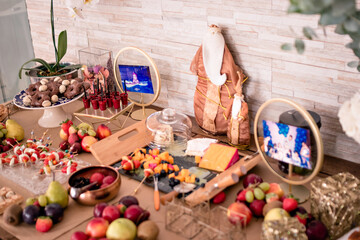 a table decorated with saints and cheeses, fruits and sweets