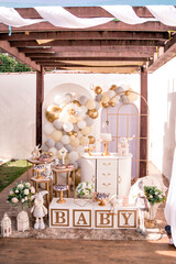 white and gold themed baby shower decor, teddy bears and santa claus