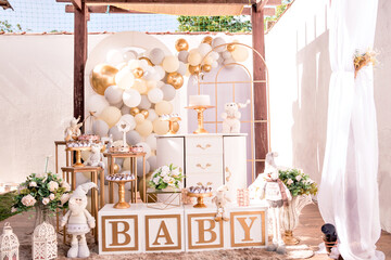 white and gold themed baby shower decor, teddy bears and santa claus