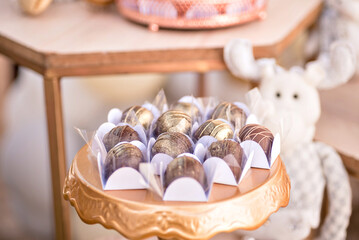 A golden tray with truffled chocolate candies on top