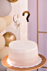 A birthday cake with a teddy bear on top and the words 