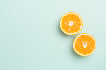 Flat lay with fresh oranges and leaves on color background