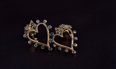 Gold earrings decorated with green gems. that shines beautifully