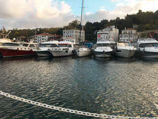 Wight yachts and speed boats at harbor. Yachts moored in the port. Ocean Coast pier. High class lifestyle. Yachting. Expensive toys. Sea ​​transport. Nautical journey. Yachting sport. Expensive yachts