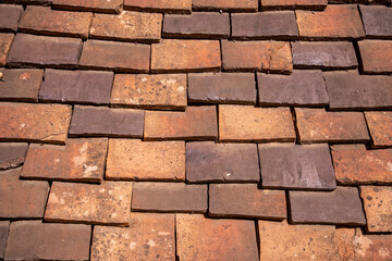 Medieval tiled roof made of handmade clay tiles as texture or background © FaRifo