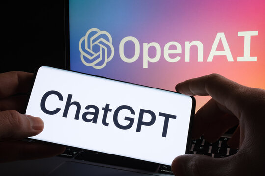 ChatGPT logo seen on smartphone and laptop display with blurred OpenAI company logotype. AI chatbot by OpenAI. Stafford, United Kingdom, December 20, 2022.