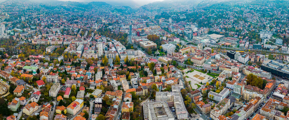 Aerial view around the capital city Sarajevo in Bosnia and Herzegovina on a cloudy and foggy day in autumn.	