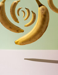 A whirlwind of bananas in the air. Pastel background. Crypto art and modern. Synchronized yellow...