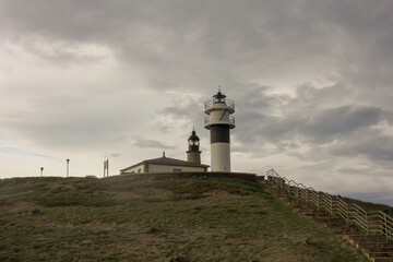Fototapeta na wymiar a view of two lighthouses with a cloudy sky