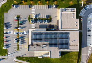 Array of solar panels on the roof of a commercial building top down