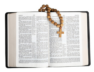 Old open Bible with wooden cross