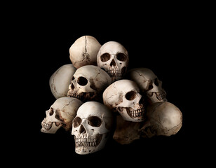 Many human skulls on black background