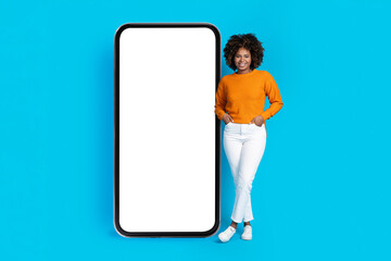 Cool african american young lady posing by big phone, mockup