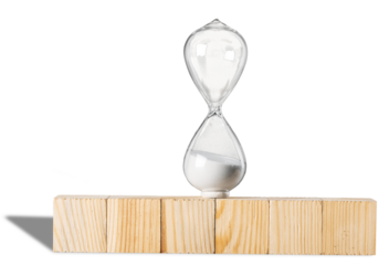 Hourglass on stack wooden cube