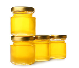 Jars with fresh honey on white background